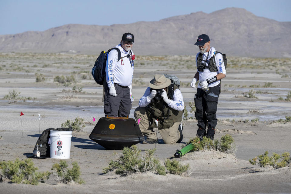 A recovery crew, including OSIRIS-REx Principal Investigator Dante Lauretta at far right, inspects the asteroid sample return capsule shortly after its landing in the Utah desert. / Credit: NASA/Keegan Barber