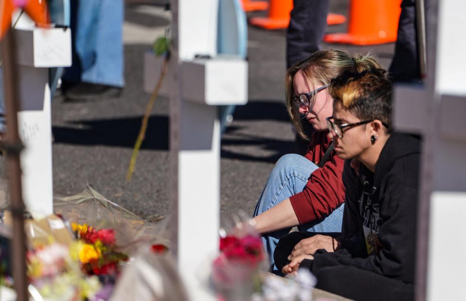 People pay their respects at a memorial display set up to remember the five victims of the Club Q shooting in Colorado Springs, Colorado, on Tuesday, Nov. 22, 2022.