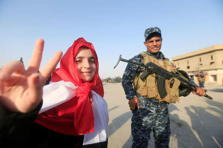 An Iraqi girl gestures as she celebrates in West Mosul, Iraq July 9, 2017. REUTERS/Alaa Al-Marjani