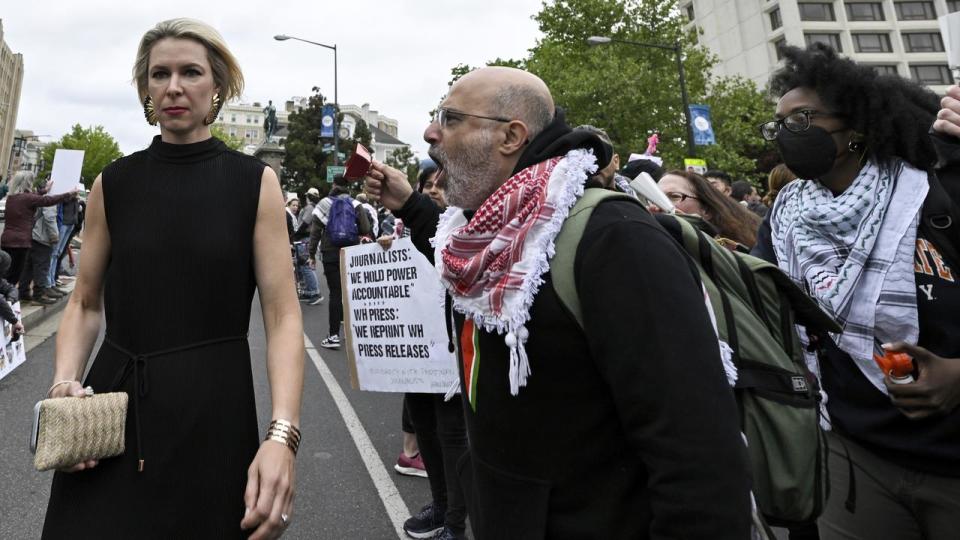 A demonstrator confronts a woman
