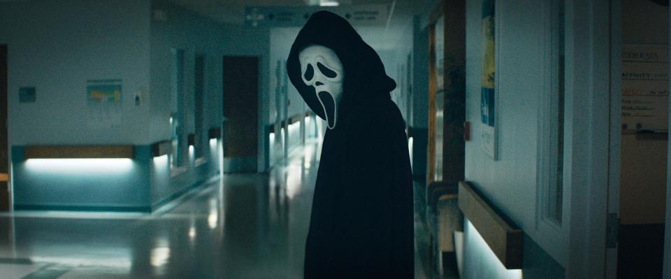 Ghostface standing in an empty hospital hallway