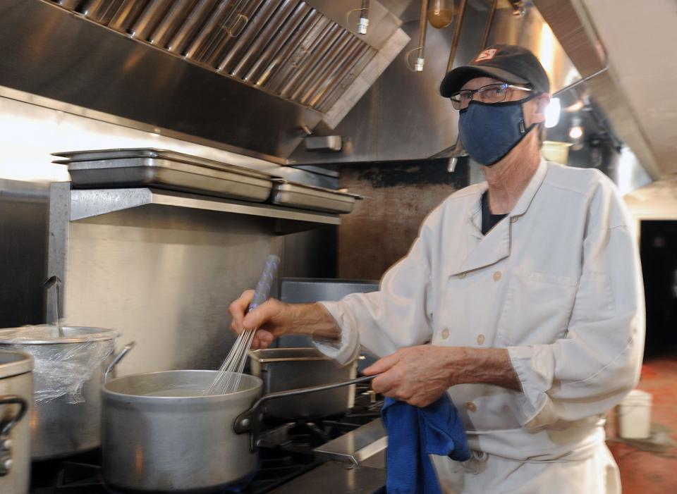 Ace O'Brien, sous chef at Longfellow's Wayside Inn in Sudbury, prepares a dish. The restaurant industry has been hit especially hard since the start of the pandemic, food industry professionals say.