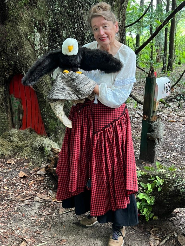 Nancy McClure, in front of the whimsical door on the oak tree on the Maclay Gardens trail, has written a child-size booklet with colorful paintings of the tree’s residents and visitors and how they came to choose the Maclay Gardens tree.