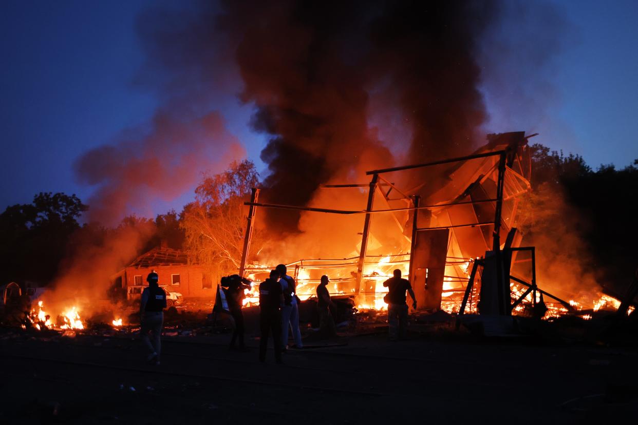 Flames rise from a structure after it was hit by a projectile in Druzhkivka, Ukraine. In recent weeks, Russia has concentrated its firepower on Ukraine's Donbas region, where it has long backed two separatist regions at war with the Ukrainian government since 2014.