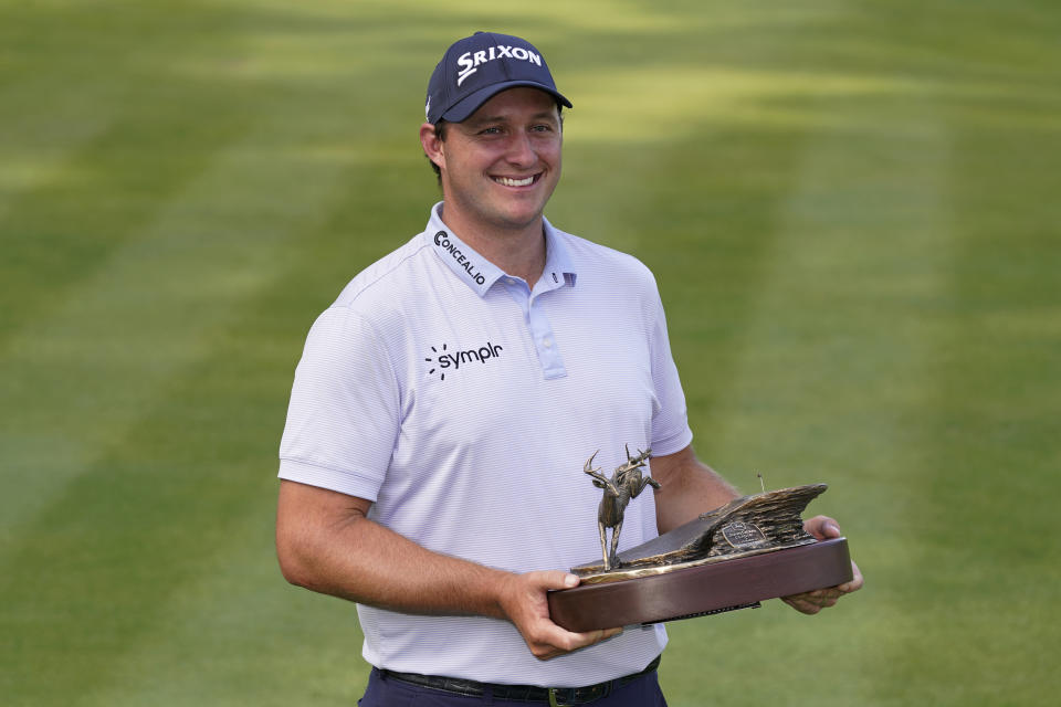 Sepp Straka, of Austria, holds the trophy after winning the John Deere Classic golf tournament, Sunday, July 9, 2023, at TPC Deere Run in Silvis, Ill. (AP Photo/Charlie Neibergall)