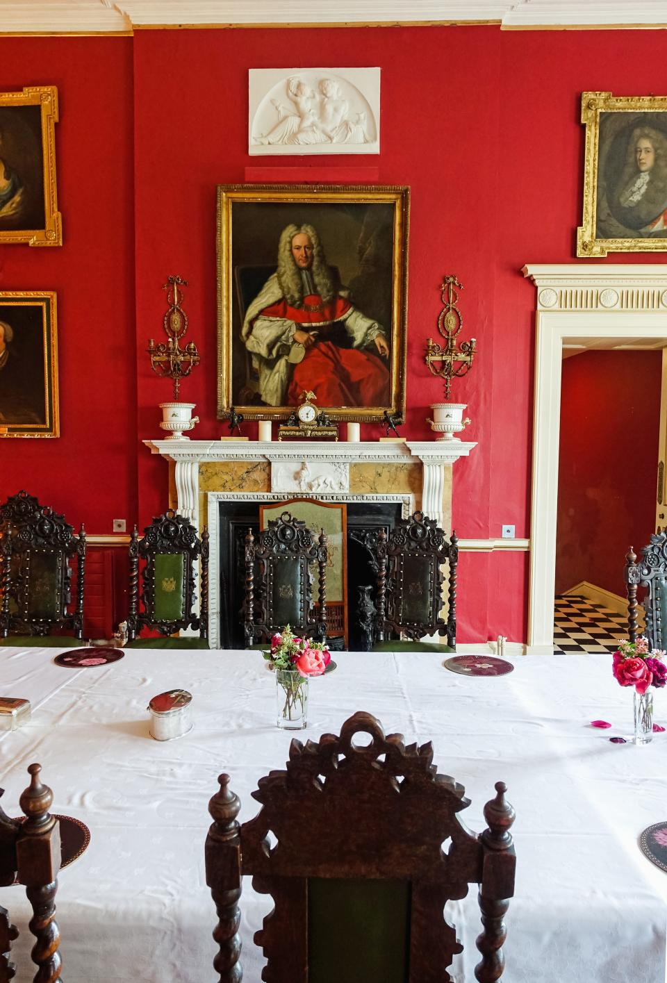 The dining room is covered with family portraits dating back to the 1700s. The crimson-colored walls add to the drama created by the dark-wood, Baronial-style furniture that was made for the house in the 19th century. “That heavy, black pseudo-Jacobean-style furniture was a new fashion at the beginning of the 19th century,” notes Fitzgerald.