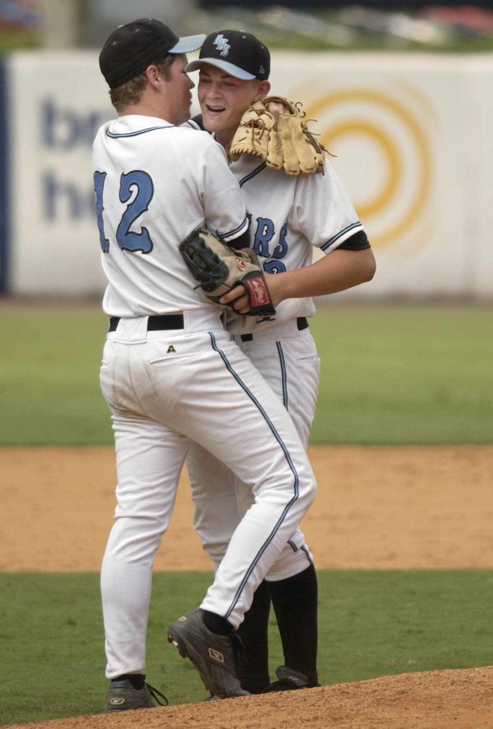 Rockledge pitcher A.J. Holbeck celebrates the team's 9-1 victory over Palm Beach Central with teammate Jeremy Revers after a 2004 state semifinal game at Legends Field in Tampa, May 26.