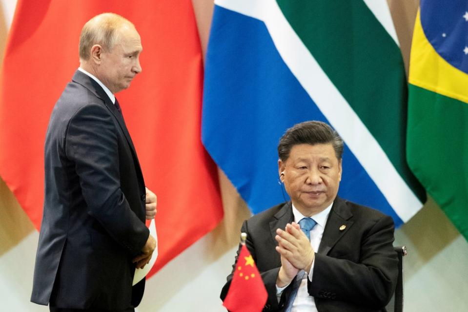 Vladimir Putin with Xi Jinping (Reuters)