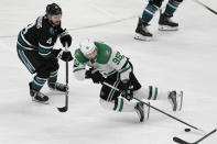 Dallas Stars center Matt Duchene (95) reaches for the puck in front of San Jose Sharks defenseman Kyle Burroughs (4) during the third period of an NHL hockey game in San Jose, Calif., Tuesday, March 26, 2024. (AP Photo/Jeff Chiu)