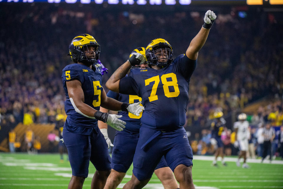 HOUSTON, TEXAS - JANUARY 08: (L-R) Josaiah Stewart #5, Mason Graham #55, and Kenneth Grant #78 of Michigan Wolverines celebrate after a play during the second half of the 2024 CFP National Championship game against the Washington Huskies at NRG Stadium on January 08, 2024 in Houston, Texas. The Michigan Wolverines won the game 34-13. (Photo by Aaron J. Thornton/Getty Images)