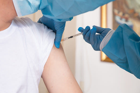 A closeup of a healthcare worker giving someone the vaccine