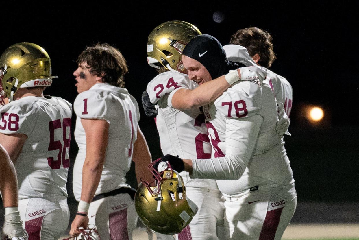 Zack Weber (24) and Nate Kreuz (78) celebrate Watterson's win in a Division III state semifinal.