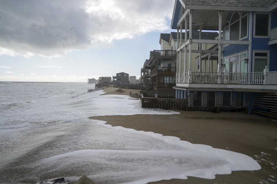 Ocean waves erode the beach behind 12 beach houses on Seagull Street on the Outer Banks of North Carolina in 2022.