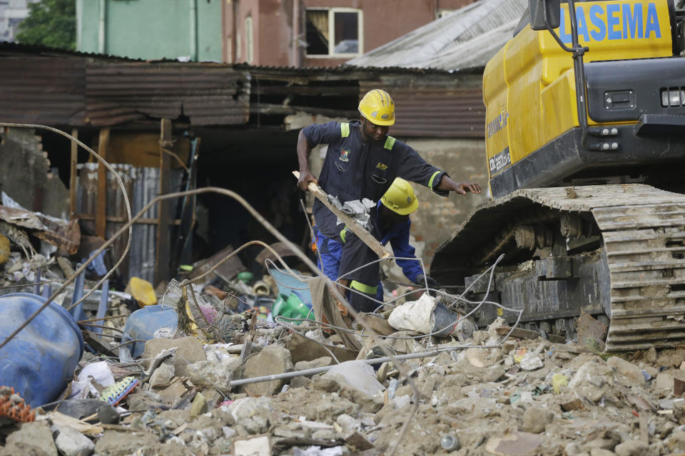 Emergency workers attend the scene after a building collapsed in Lagos, Nigeria, Thursday March 14, 2019. Search and rescue work continues in Nigeria a day after a building containing a school collapsed with scores of children said to be inside. A National Emergency Management Agency spokesman late Wednesday said 37 people had been pulled out alive, with eight bodies recovered from the ruins. An unknown number remain missing. (AP Photo/Sunday Alamba)