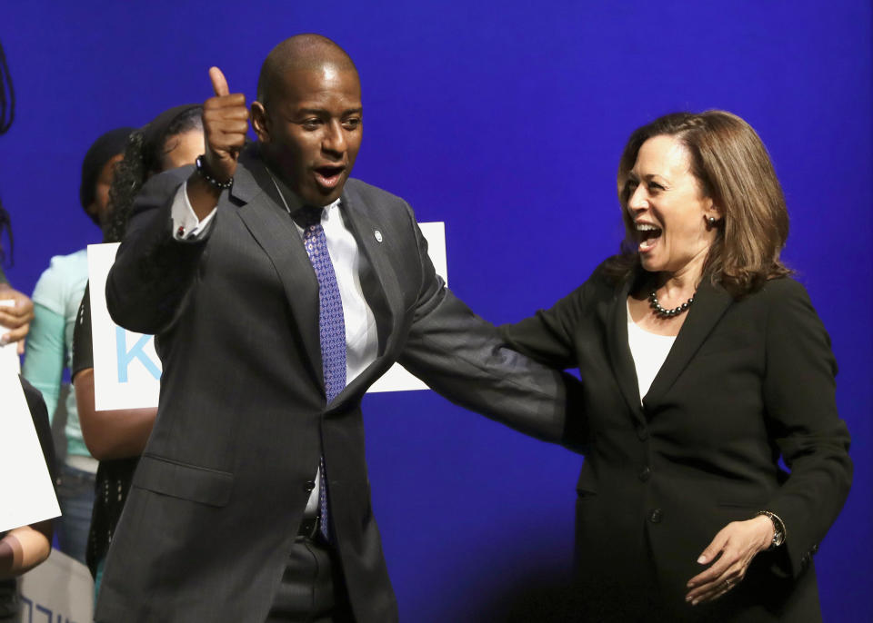 FILE- In this Oct. 29, 2018 file photo Democratic candidate for Florida governor Andrew Gillum, left, greets U.S. Sen. Kamala Harris, D-Ca., in Miami. Florida, the site of both a horrific school shooting and a monstrous killer hurricane in the last few months, has become the epicenter of the nation's polarizing political battles. (AP Photo/Lynne Sladky, File)