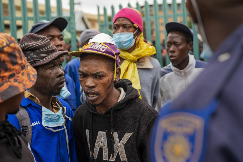 Homeless people stay at the Caledonian stadium downtown Pretoria, South Africa, Thursday April 2, 2020, after being rounded up by police in an effort to enforce a 21 day lockdown to control the spread of the coronavirus. Many of them being addicted, they are receiving methadone syrup from a local NGO, and were complaining about the lack of sanitizer and soap. The new coronavirus causes mild or moderate symptoms for most people, but for some, especially older adults and people with existing health problems, it can cause more severe illness or death.(AP Photo/Jerome Delay)