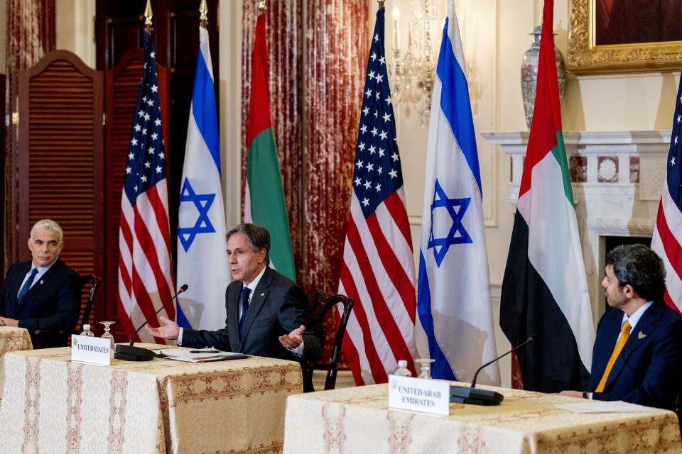 Secretary of State Antony Blinken accompanied by Israeli Foreign Minister Yair Lapid, left, and United Arab Emirates Foreign Minister Sheikh Abdullah bin Zayed al-Nahyanin, right, speaks at a joint news conference at the State Department in Washington, Wednesday, Oct. 13, 2021. (AP Photo/Andrew Harnik, Pool)