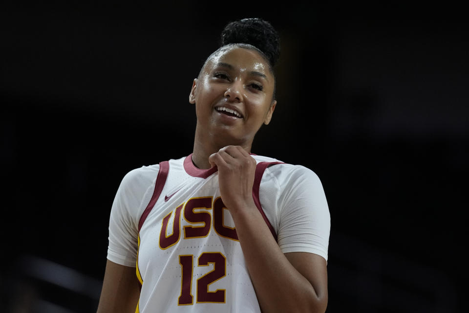 Southern California guard JuJu Watkins smiles from the court during the first half of an NCAA college basketball game against the Le Moyne in Los Angeles, Monday, Nov. 13, 2023. (AP Photo/Ashley Landis)