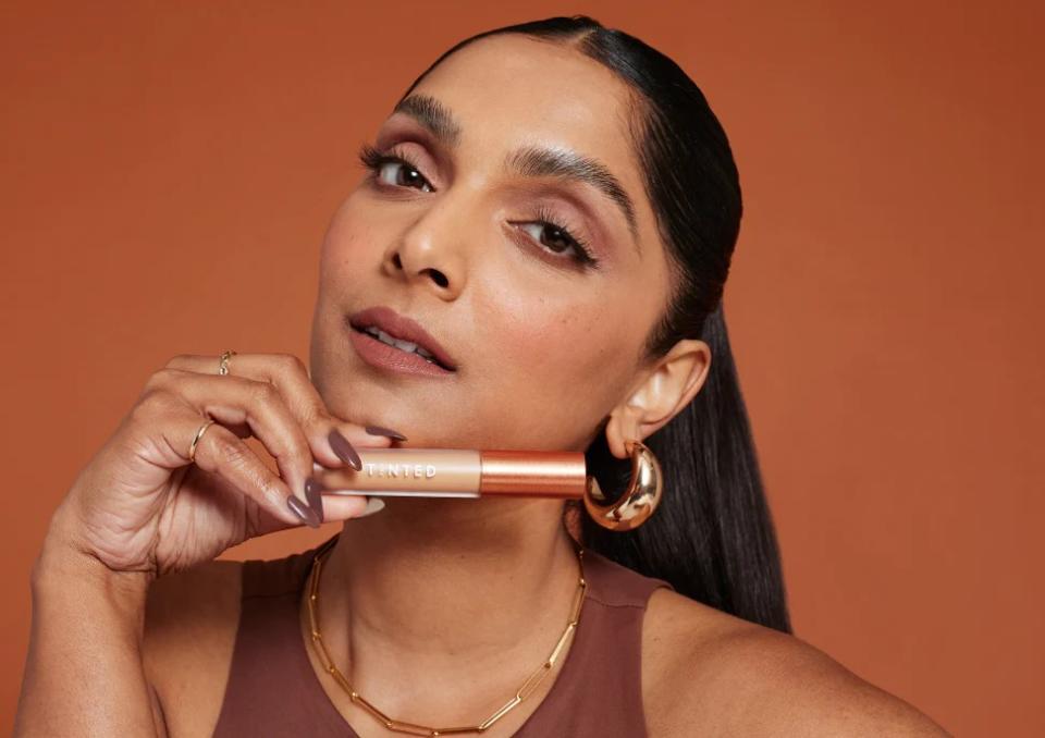 woman holding Live Tinted products