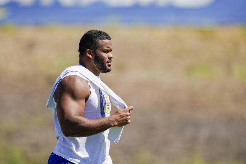 Rams defensive tackle Aaron Donald watches a joint practice with the Raiders.