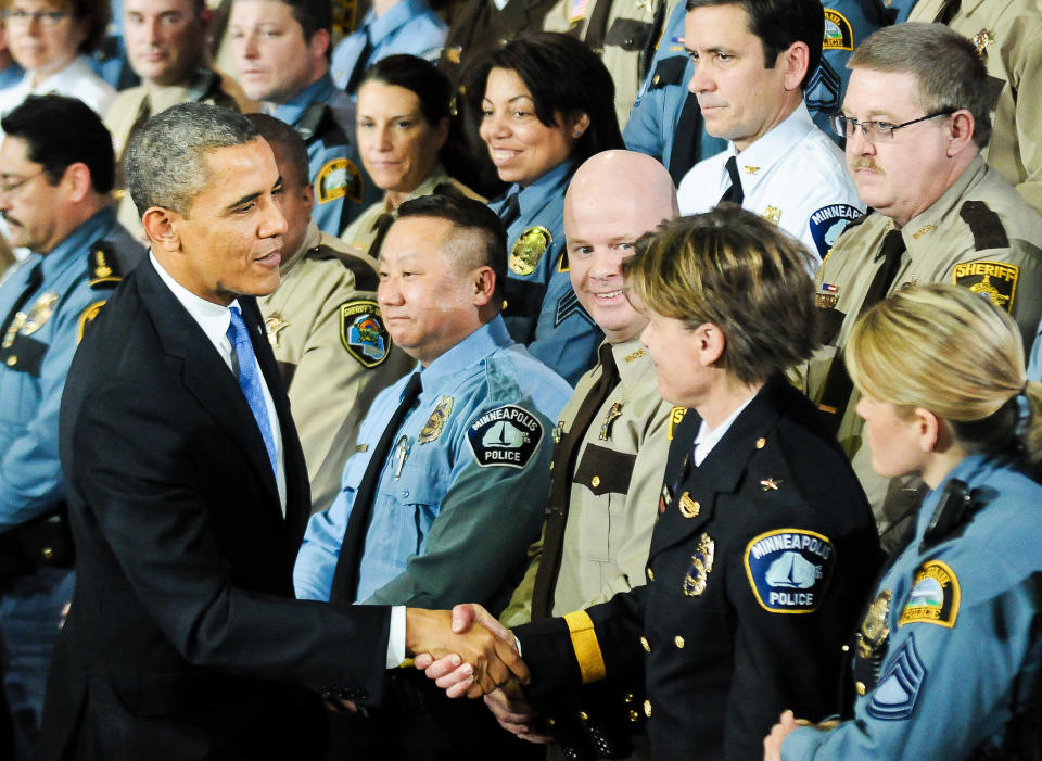 President Barack Obama greets law enforcement officers after speaking at the Minneapolis Police Department Special Operations Center on February 4, 2013, in Minneapolis, Minnesota. Obama was promoting a ban on assault weapons and expanded background checks on gun buyers. 