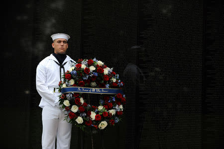 U. S Navy SN Caleb Harrington, Fresno, will assist U.S. Secretary of Defense James Mattis, General John Kelly, White House Chief of Staff and Cindy McCain, wife of late Senator John McCain, in laying a ceremonial wreath honoring all whose lives were lost during the Vietnam War at the Vietnam Veterans Memorial in Washington, U.S., September 1, 2018. REUTERS/Mary F. Calvert