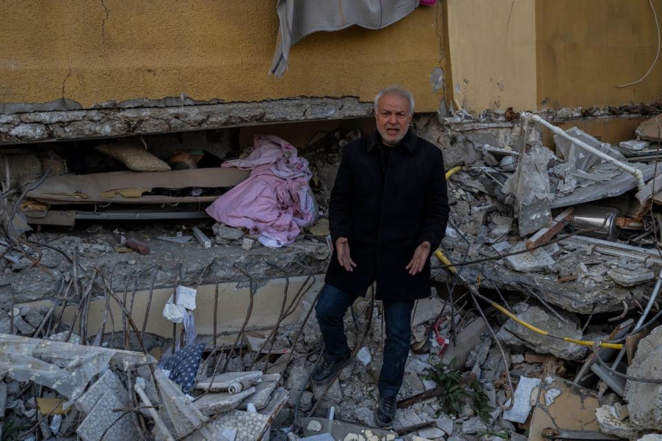 Zafer Mahmut Boncuk, 60, screams angrily next to the body of his dead mother, Ozcan Boncuk (AP)