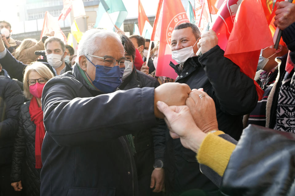 Portuguese Prime Minister and Socialist Party Secretary General Antonio Costa, center, bumps fists with supporters during an election campaign event in the outskirts of Lisbon, Thursday, Jan. 27, 2022. Portugal holds a general election on Jan. 30. (AP Photo/Armando Franca)