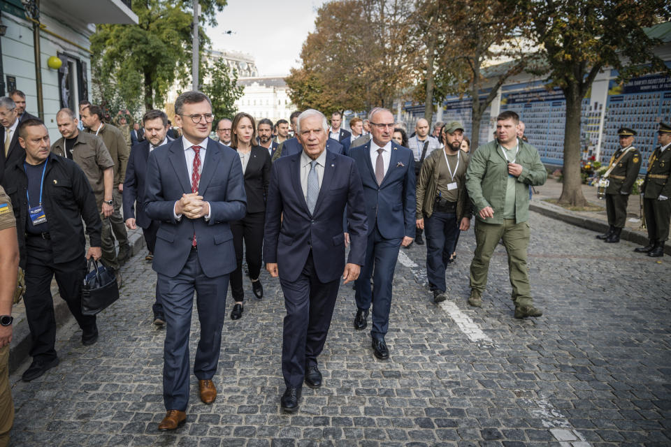 Ukrainian Foreign Minister Dmytro Kuleba, centre left, and European Union Foreign Policy Chief Josep Borrell visit the Memory Wall of Fallen Defenders of Ukraine in Kyiv, Monday, Oct. 2, 2023. Some of Europe's top diplomats have gathered in Kyiv in a display of support for Ukraine's fight against Russia's invasion as signs emerge of political strain in Europe and the United States about the war. (Press service of the Ministry of Foreign Affairs of Ukraine via AP)