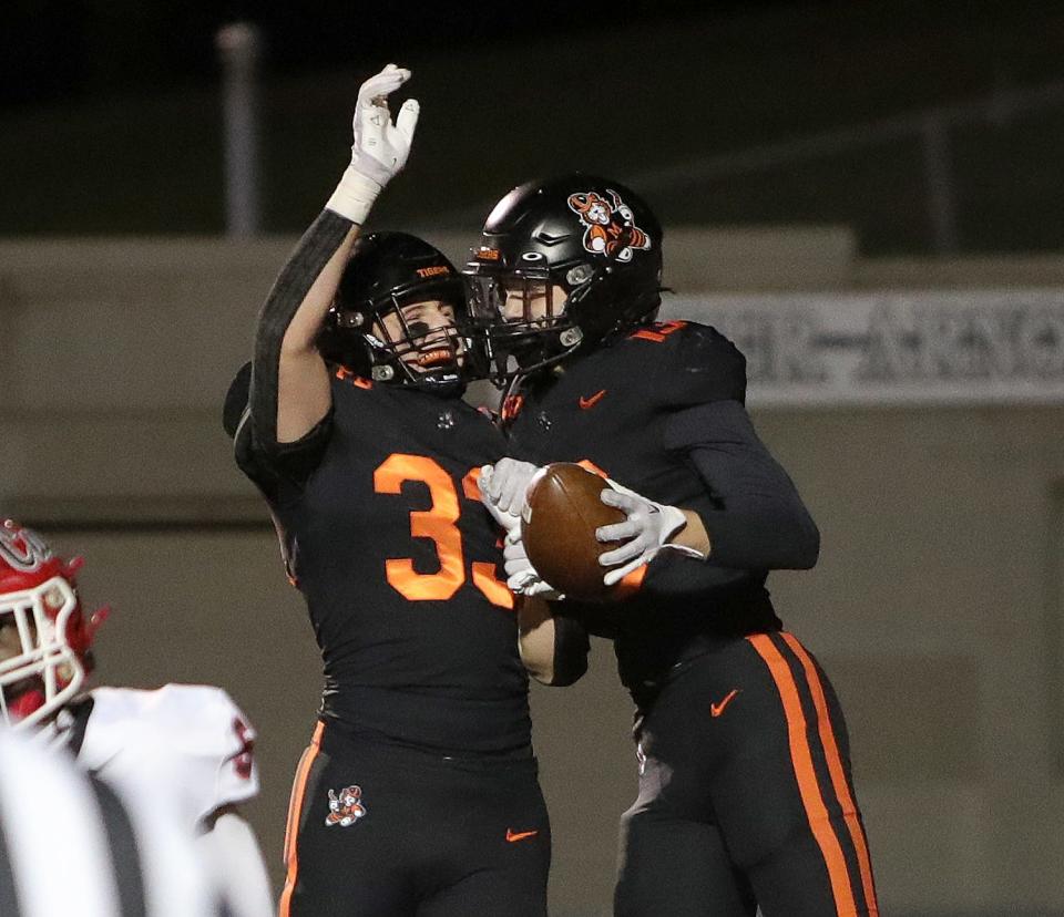 Massillon's Cody Fair, left, and Vito McConnell celebrate in the end zone after McConnell's fumble return touchdown during their playoff game against Westerville South, Friday, Nov. 3, 2023.