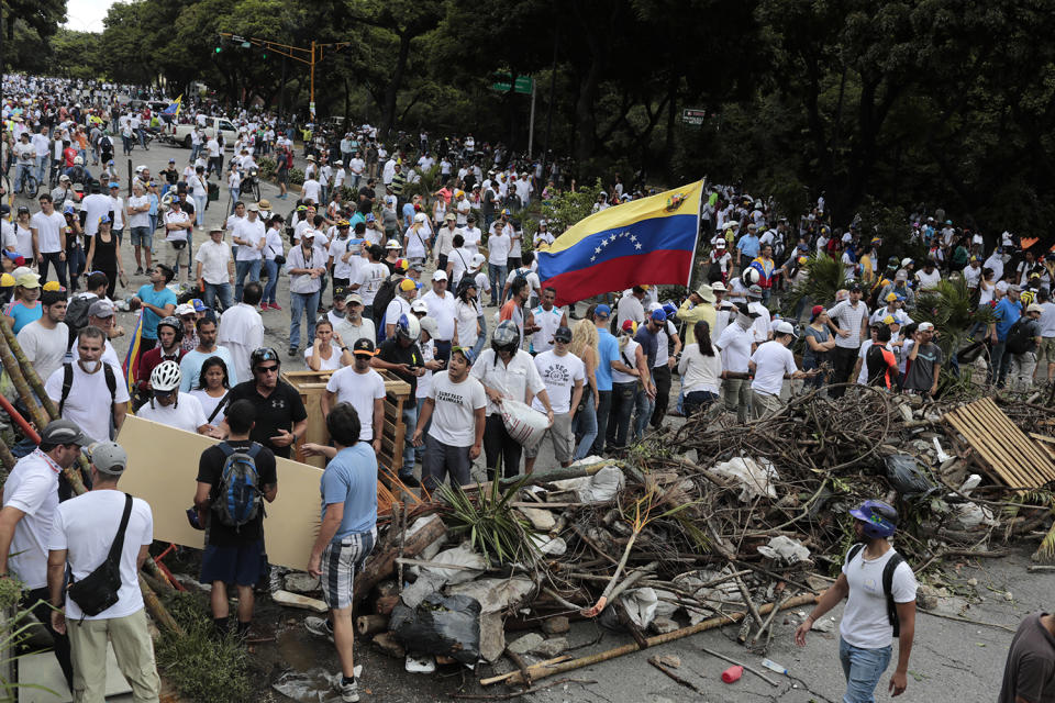 <p>Opposition supporters stand behind a barricade as the Constituent Assembly election was being carried out in Caracas, Venezuela, July 30, 2017. (Marco Bello/Reuters) </p>