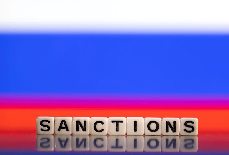 FILE PHOTO: Illustration shows letters arranged to read "Sanctions" in front of Russian flag colors