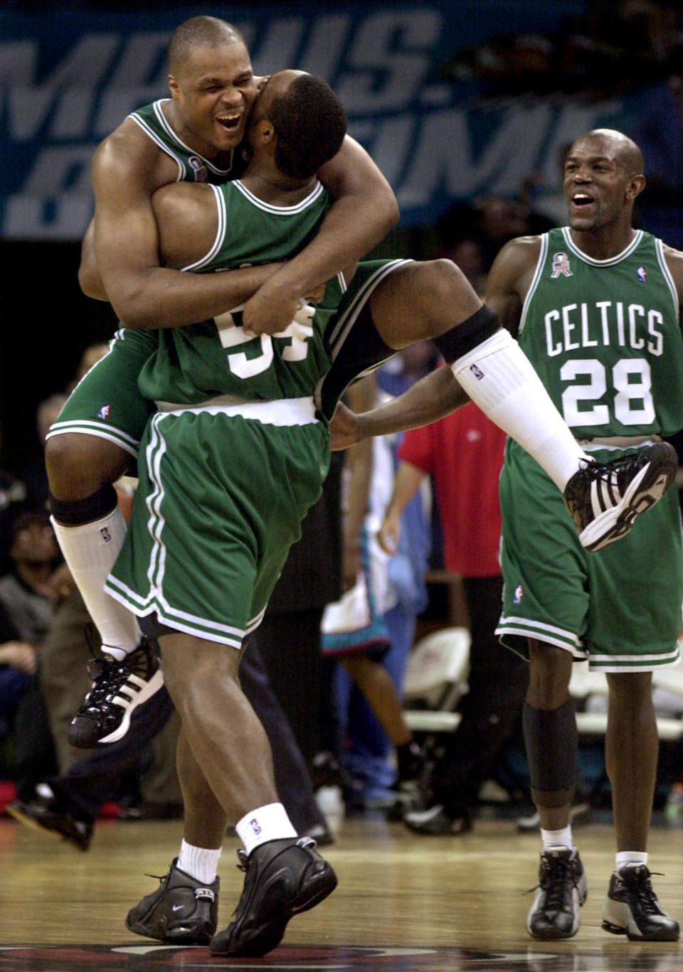 Boston Celtics forward Antoine Walker celebrates with teammate Rodney Rogers (54) as Celtics’ Tony Delk (28) looks on after Walker scored from beyond half court at the buzzer against the <a class="link " href="https://sports.yahoo.com/nba/teams/memphis/" data-i13n="sec:content-canvas;subsec:anchor_text;elm:context_link" data-ylk="slk:Memphis Grizzlies;sec:content-canvas;subsec:anchor_text;elm:context_link;itc:0">Memphis Grizzlies</a> on Friday, March 15, 2002, at the Pyramid in Memphis, Tenn. Boston won 103-97. (AP Photo/Lance Murphey)