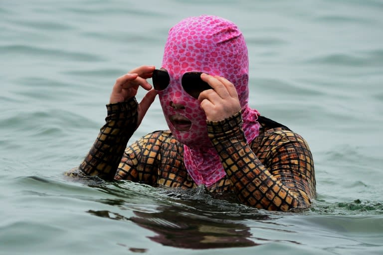 A swimmer tries to keep cool during a heatwave by swimming at a beach in Qingdao, in eastern China's Shandong province (STR)