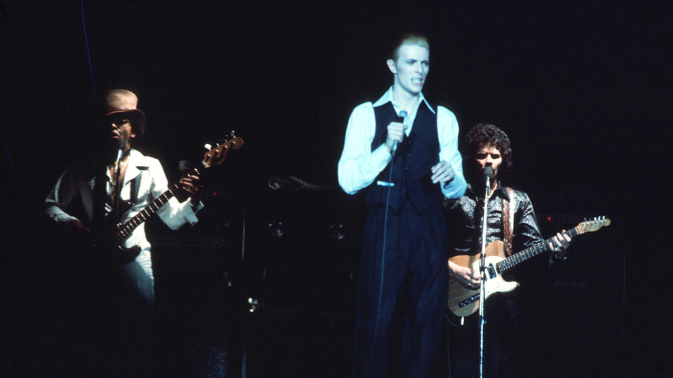 David Bowie performing on stage with George Murray and Stacy Heydon at Wembley Arena, London 03 May 1976.