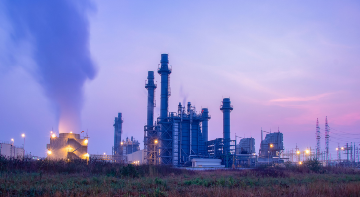 Natural Gas Combined Cycle Power Plant with sunset and light orange. Best natural gas stocks to buy.