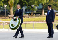 <p>President Barack Obama (L) carries a wreath as Japanese Prime Minister Shinzo Abe looks on, in front of a cenotaph at Hiroshima Peace Memorial Park in Hiroshima, Japan May 27, 2016. (Photo: Toru Hanai/Reuters) </p>