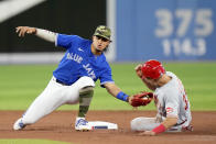 Cincinnati Reds second baseman Alejo Lopez (35) gets caught stealing by Toronto Blue Jays second baseman Santiago Espinal (5) during the third inning of a baseball game in Toronto, Saturday, May 21, 2022. (Frank Gunn/The Canadian Press via AP)