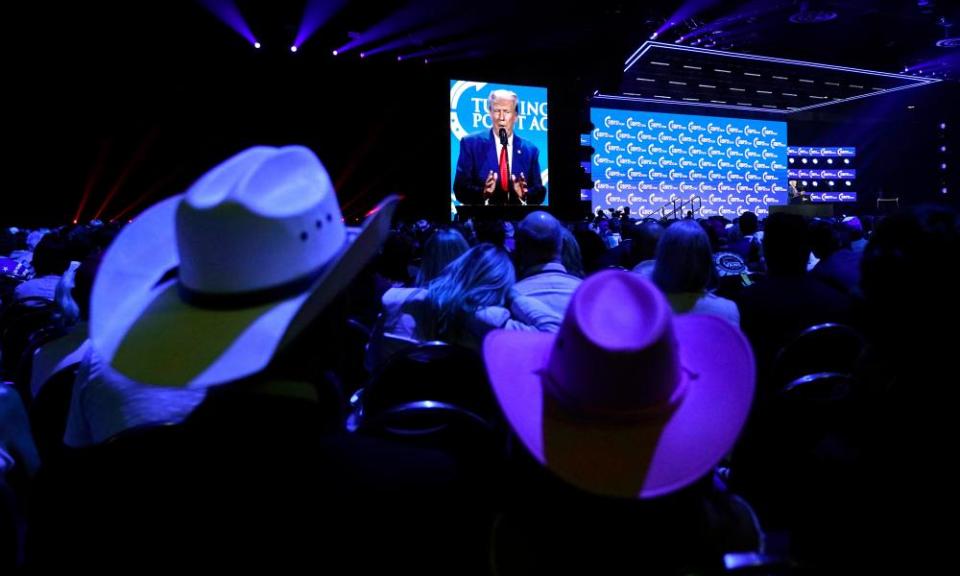 People listen as Trump speaks at the Turning Point Action conference on 15 July.