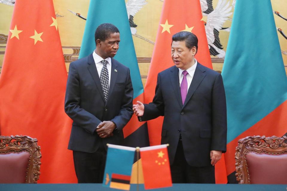 Chinese President Xi Jinping (R) talks with Zambia’s President Edgar Chagwa Lungu (L) during a signing ceremony at the Great Hall of the People on March 30, 2015 in Beijing, China. (Photo by Feng Li/Getty Images)