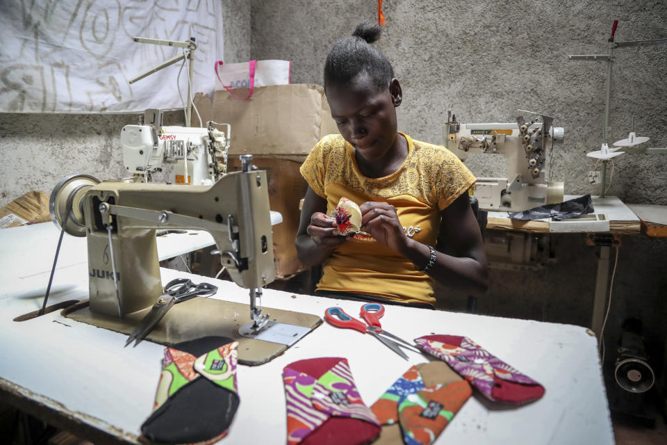 Winnie Adhiambo makes re-useable sanitary pads with a sewing machine at Amani Kibera Community centre in the Kibera neighbourhood of Nairobi, Kenya Tuesday, March. 7, 2023. Kenyan senator Gloria Orwoba has said that she attended parliament last month while wearing a white pantsuit stained by her menstruation in order to combat the stigma surrounding women's monthly periods. (AP Photo/Brian Inganga)