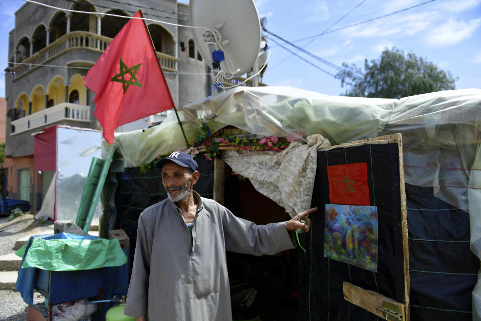 Allal Oli Lahcen stands outside his tent after he was displaced by the earthquake, Amizmiz, near Marrakech, Thursday, April 4, 2024. (AP Photo)