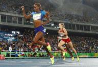 2016 Rio Olympics - Athletics - Final - Women's 400m Hurdles Final - Olympic Stadium - Rio de Janeiro, Brazil - 18/08/2016. Dalilah Muhammad (USA) of USA crosses the finish line to win the gold, ahead of silver medallist Sara Slott Petersen (DEN) of Denmark and bronze medallist Ashley Spencer (USA) of USA. REUTERS/Kai Pfaffenbach