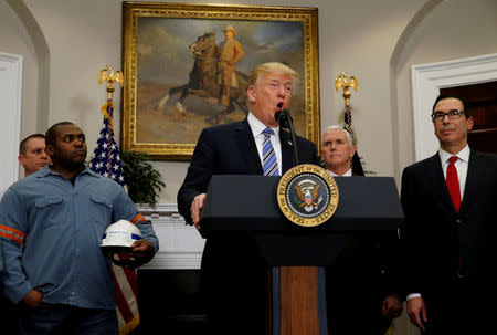 FILE PHOTO: U.S. President Donald Trump makes an announcement about a presidential proclamation placing tariffs on steel and aluminum imports while surrounded by workers from the steel and aluminum industries at the White House in Washington, U.S. March 8, 2018. REUTERS/Leah Millis/File Photo