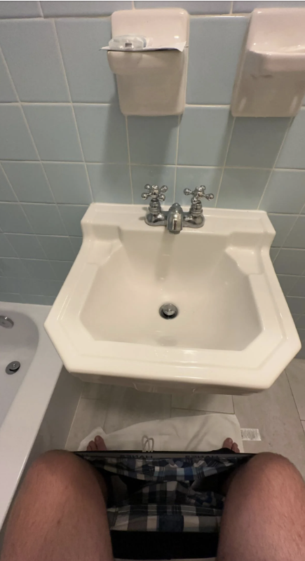 A sink right in front of a toilet