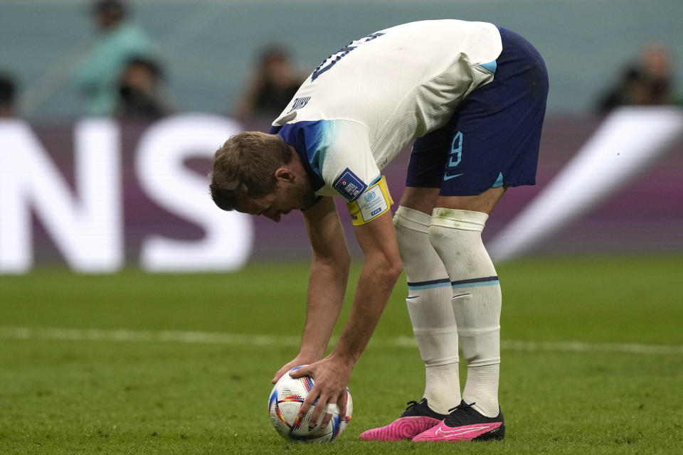 England's Harry Kane prepares the ball at the penalty spot during the World Cup quarterfinal soccer match between England and France, at the Al Bayt Stadium in Al Khor, Qatar, Saturday, Dec. 10, 2022. (AP Photo/Frank Augstein)