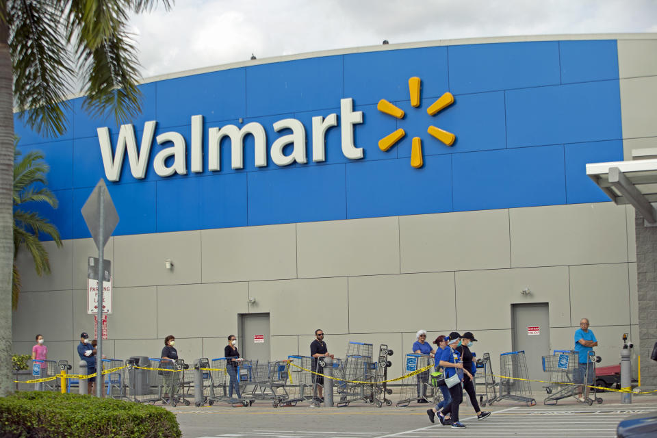 People waiting outside in line to enter the Walmart Supercenter as the coronavirus pandemic continues on Sunday, April 5, 2020 in Miami. (David Santiago/Miami Herald/Tribune News Service via Getty Images)