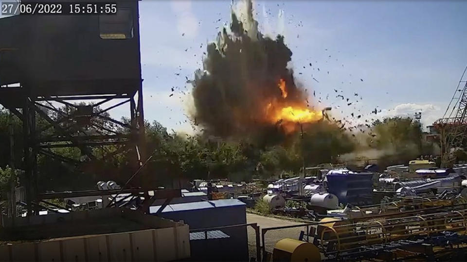 Video footage shows the moment of impact, with a black cloud of smoke, an intense blaze and flying debris.