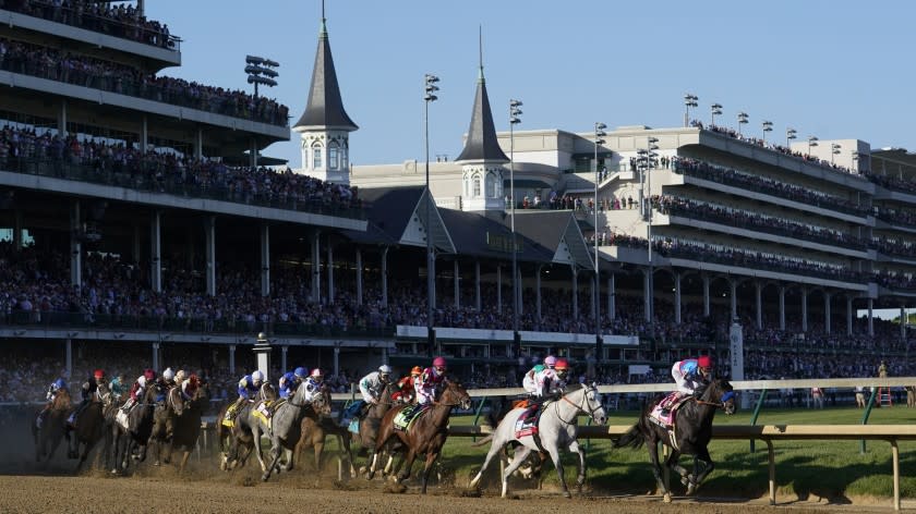 Medina Spirit leads the field around the first turn on the way to winning the Kentucky Derby