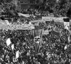 FILE - This Aug. 16, 1953 file photo shows a selection of the huge crowd massed in parliament square after Prime Minister Mohammad Mossadegh announced he had smashed a pro-shah coup d'etat in Tehran, Iran. In 2018, as Iran deals with President Donald Trump's decision to pull America from the nuclear deal with world powers, more are invoking the 1953 CIA-backed coup that toppled Mossadegh as proof the U.S. cannot be trusted. (AP Photo, File)